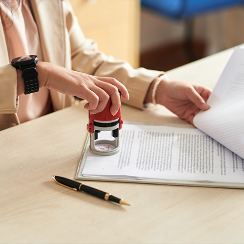 businesswoman applying company seal