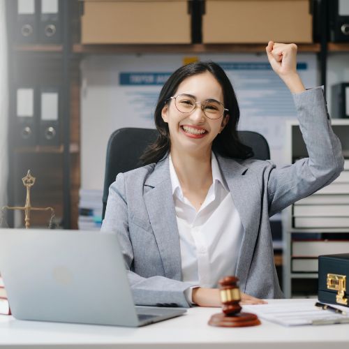 Beautiful woman lawyer working and gavel, tablet, laptop in front, Advice justice and law concept.