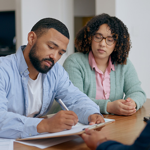 Man, woman and signature for contract in home for application, insurance or form for protection