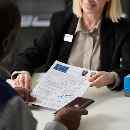 Close up of smiling woman handing approved visa