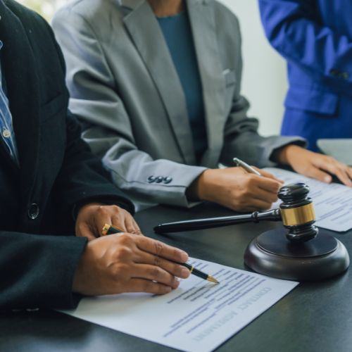 Business lawyer team working with law firms contracts in working room.