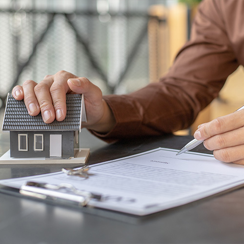 Sales manager or real estate agent prepares to hand over the keys and the house together with the insurance to the customer, Attention to property services and insurance concept.