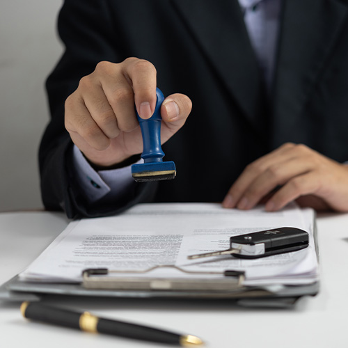 Businessman signing a contract for buying of selling a car.Car rental service.